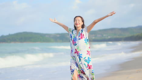 Young-happy-Asian-woman-smiles-and-rejoices-on-beach
