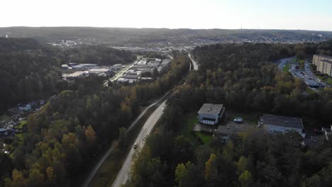 Drone-pull-back-over-suburban-road-and-buildings-of-Gothenburg-Sweden