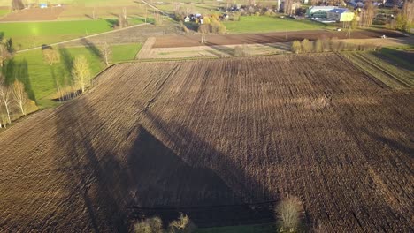 Plowed-Dirt-Field-on-Farming-Land-by-Farm-House