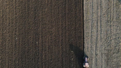 Overhead-Birds-Eye-View-of-Farmer-Ploughing-A-Field---Aerial-Drone-Footage