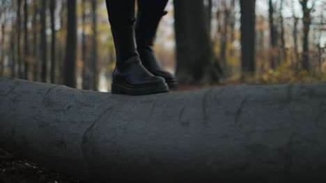 Fall-Boots-Close-Up-A-close-up-of-woman's-boots-while-trying-to-keep-balance-on-a-log
