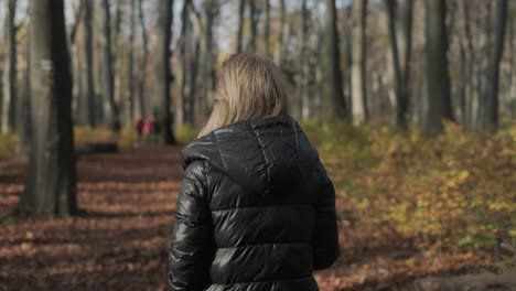 Autumn-Walk-In-The-Woods-Woman-in-black-jacket-lonely-walking-in-park-in-autumn