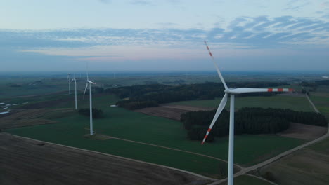 Towering-white-windmills-of-Lubawa,-Poland--aerial