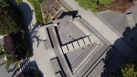 aerial-birds-eye-view-fly-over-drop-towards-a-closeup-of-an-atheistic-modern-druid-sacrificial-concrete-worship-platform-where-ladies-approach-the-pagan-walkway-to-celebrate-an-afternoon-lunch-2-2