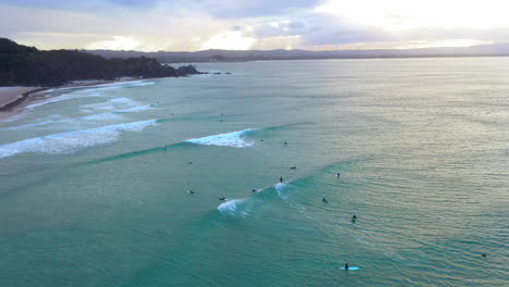 Drone-of-surfers-at-sunset-at-Wategos-Beach-Byron-Bay-Australia