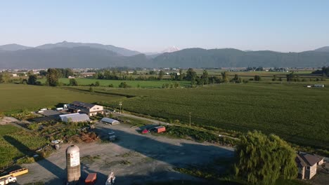1-3-Mountain-Valley-farmland-Aerial-panout-over-winery-fruit-organic-grapes-harvest-ready-crops-on-a-hot-sunny-day