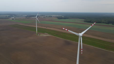 Small-windmill-farm-standing-on-rural-farm-field-in-Poland