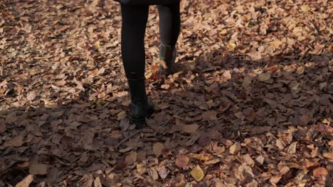 Walking-on-Autumn-Leaves-A-Close-up-of-Woman's-Boots-While-Walking-in-Forest