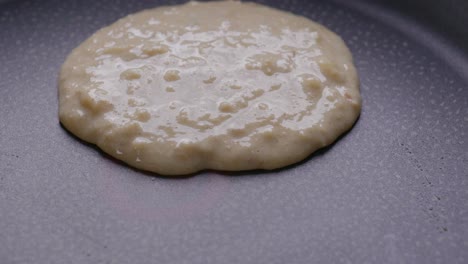 Close-up-of-pouring-pancake-batter-on-a-hot-pan