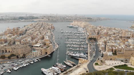 Wide-panning-4k-aerial-drone-footage-of-the-harbors-of-'Three-Cities-of-Malta'-along-the-coast-of-the-Mediterranean-Ocean