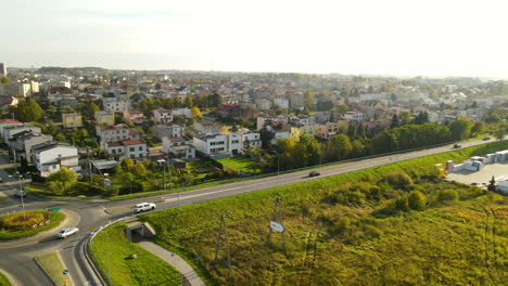 Aerial-backwards-shot-of-rural-roundabout-and-beautiful-cityscape-of-Lubawa-in-Poland