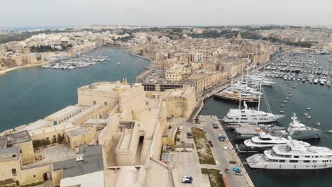 Vittoriosa-yacht-Marina-on-the-Grand-Harbour-in-the-Three-Cities-of-Malta---Fly-over-Aerial-shot