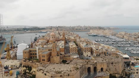 Grand-Harbour-of-Valetta-beneath-the-Three-Cities,-in-Malta---Orbit-aerial-shot