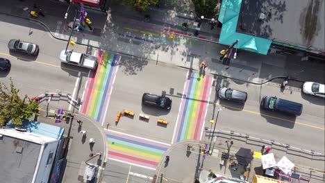 super-slow-aerial-twist-over-gay-pride-LGBTQ-downtown-community-with-4-painted-road-flags-describing-sexuality-of-the-village-davie-and-bute-vancouver-canada-1-2