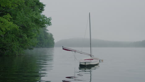 A-sailboat-in-a-lake-on-a-foggy-day