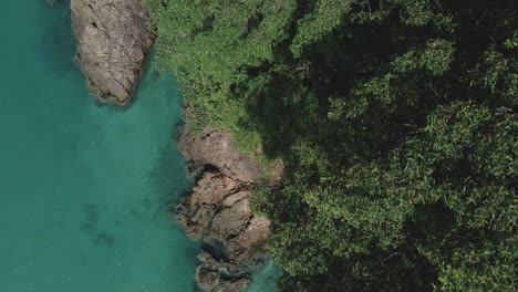 Aerial-top-view-tropical-ocean-jungle-granite-coastline-turquoise-water