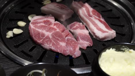 Raw-Pork-Belly-Cooked-In-Korean-Barbeque-Grill---close-up-shot