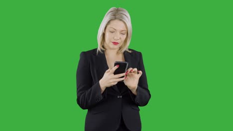 An-attractive-happy-blonde-haired-businesswoman-is-using-an-app-on-her-mobile-cell-phone