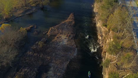Static-aerial-shot-of-two-kayakers-paddling-through-small-section-of-whitewater-on-Elkhorn-Creek