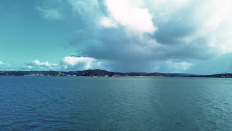 Tranquil-water-in-bay-of-islands-in-New-Zealand-with-clouds,-slow-motion