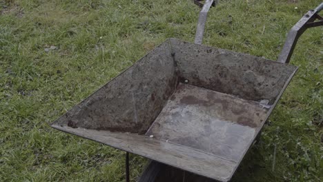 Old-Rusty-Steel-Wheelbarrow-in-The-Rain-4K