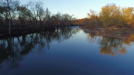 Fast-moving-aerial-shot-flying-over-Elkhorn-Creek-at-sunset-in-the-fall