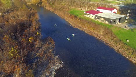 Aerial-shot-following-three-kayakers-down-Elkhorn-Creek-in-fall