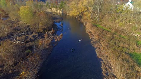 Aerial-shot-of-three-Kayakers-on-Elkhorn-Creek-in-the-Fall