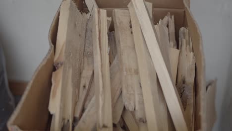 Hands-Throwing-Wood-Pieces-to-Cardboard-4K