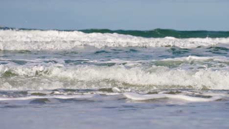 Slow-motion-view-of-breaking-turquoise-waves-on-Sylt-beach-in-Germany