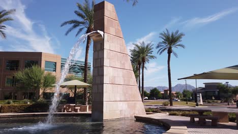 A-30-foot-brick-fountain-stands-as-a-landmark-for-traffic-along-a-busy-roadway,-Scottsdale,-Arizona