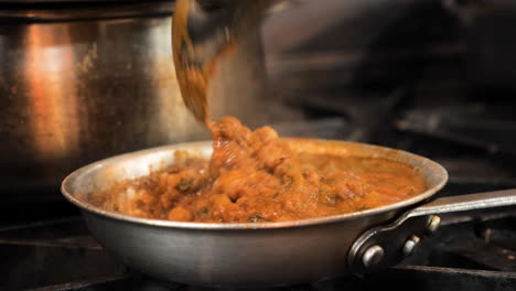 Chef-stirs-authentic-Chana-Masala-in-commercial-restaurant-kitchen,-slow-motion-slider-close-up-HD