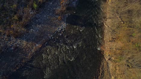 Aerial-shot-of-Elkhorn-Creek-ascending-from-close-up-of-rapids-to-bird’s-eye-view