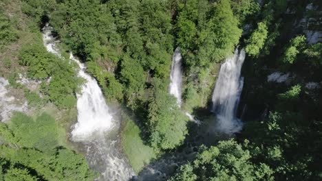 Drone-zoom-in-shot-of-three-impressive-waterfalls-after-rainfall