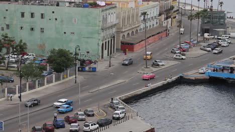 Vintage-Antique-Convertible-Cars-Drive-Past-Down-Below-in-Havana-Cuba