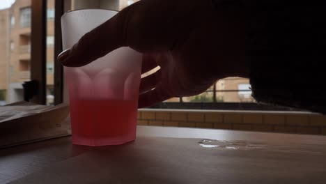 Drinking-pink-lemonade,-Apartments-view,-4k