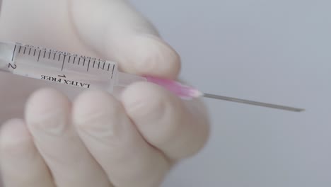 Hand-With-Glove-Remove-Needle-From-Syringe,-Close-Up-Shot