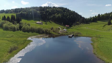 Drone-shot-of-a-beautiful-mountain-lake-with-sun-reflection
