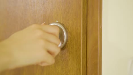 Woman-locking-the-door-for-safety--close-up
