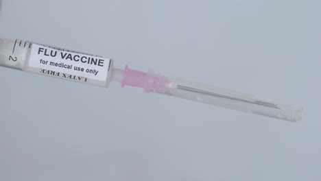 Medical-Man-Removing-The-Needle-From-Injection-Filled-With-Flu-Vaccine,-Close-Up-Shot