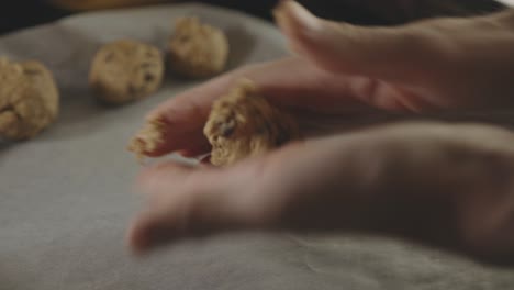 Baker's-Hands-Rolling-Chocolate-Chip-Cookie-For-Baking-In-The-Kitchen---close-up