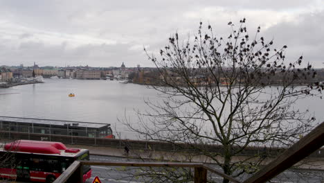 Slow-motion-panoramic-pan-over-Stockholm-harbor,-downtown-and-old-town