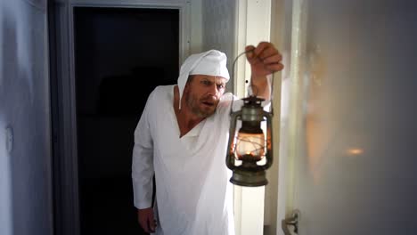Ebeneezer-Scrooge-is-looking-with-his-gas-lantern-as-he-hears-a-ghost-in-a-corridor