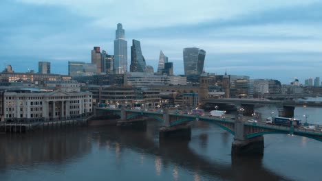 Rising-Crane-Drone-shot-of-Iconic-London-skyscrapers-and-thames-river-at-sunset