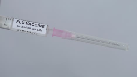 Doctor's-Hand-Attaching-Needle-To-Syringe---Flu-Vaccine---close-up