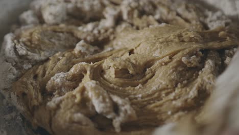 Mixing-Cookie-Batter-And-Flour-Using-A-Wooden-Spoon-In-The-Kitchen---close-up