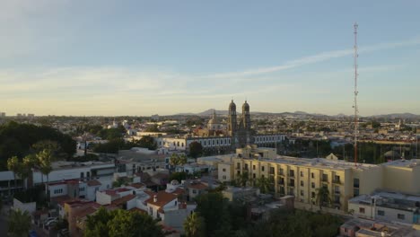 Drone-Flies-Low-Over-Trees-to-Our-Lady-of-Zapopan-in-Guadalajara,-Mexico