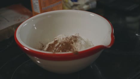 Adding-Cocoa-Powder-To-Heap-Of-Flour-In-A-Bowl---Baking-Cookies---close-up