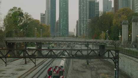 A-train-travels-with-buildings-in-the-background-in-slow-motion