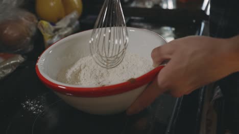 Hand-Mixing-Dry-Ingredients-In-A-Bowl-Using-Wire-Whip---close-up